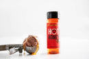 Bottle of hot honey with a scoop of ice cream on a white background