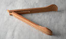 Wooden tongs on a marble surface