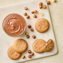 Chocolate spread with cookies and hazelnuts on a marble board