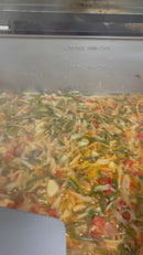 Colorful tamale filling with various vegetables being cooked