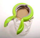 Green jar opener on a glass jar with a white background