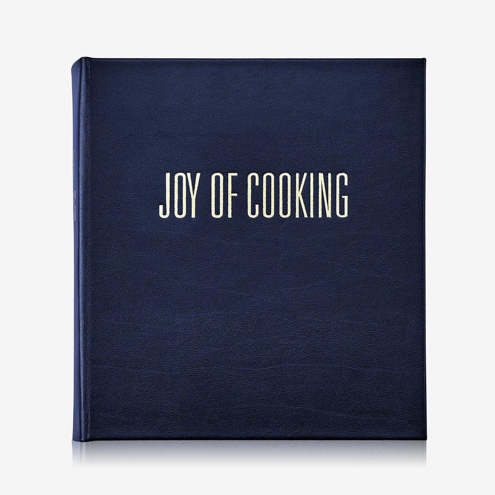 Navy blue cookbook titled 'Joy of Cooking' on a white background