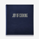 Navy blue cookbook titled 'Joy of Cooking' on a white background