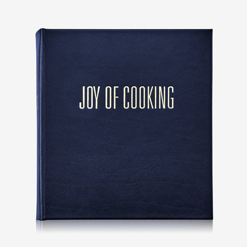 Navy blue cookbook titled 'Joy of Cooking' on a white background