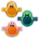 Three colorful cold packs in monster shapes.