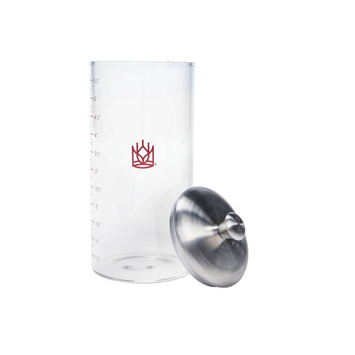 Clear measuring glass with a red logo and metal funnel on a white background