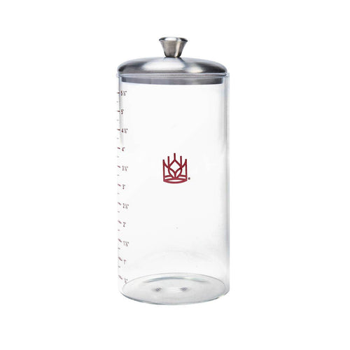 Clear glass container with silver lid and red logo on a white background