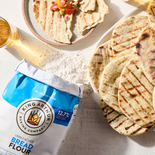 Bag of King Arthur Flour with grilled flatbreads on a table