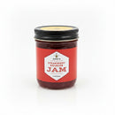 A jar of strawberry rhubarb jam on a white background.