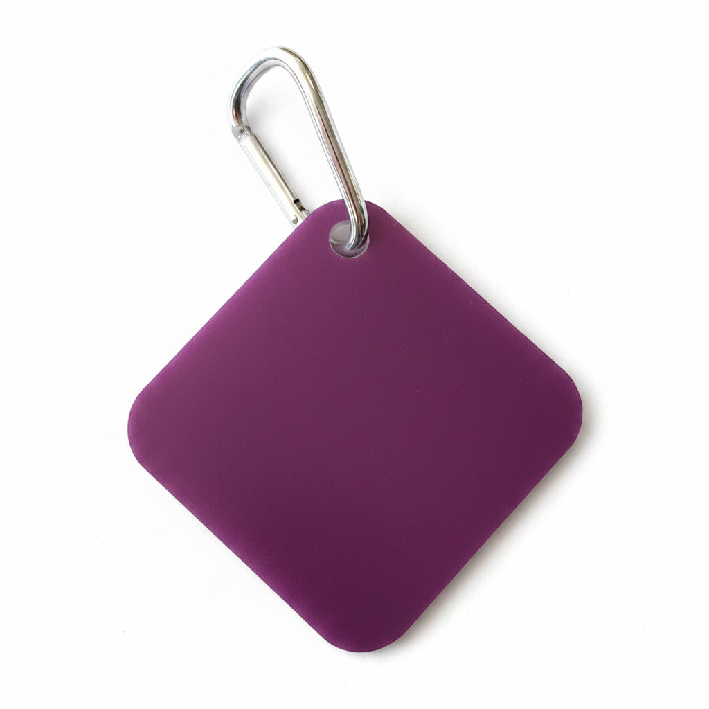 Purple square keychain with a metal carabiner on a light beige background