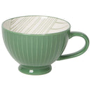 A green porcelain latte mug with a line pattern on the inside and a solid green color on the outside.
