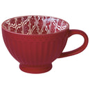 A red porcelain latte mug with a cloud pattern on the inside and a solid red color on the outside.