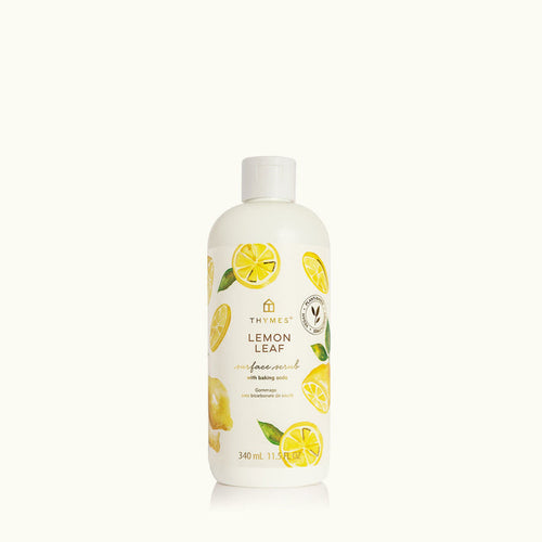 Lemon-scented surface scrub bottle with lemon illustrations on a white background