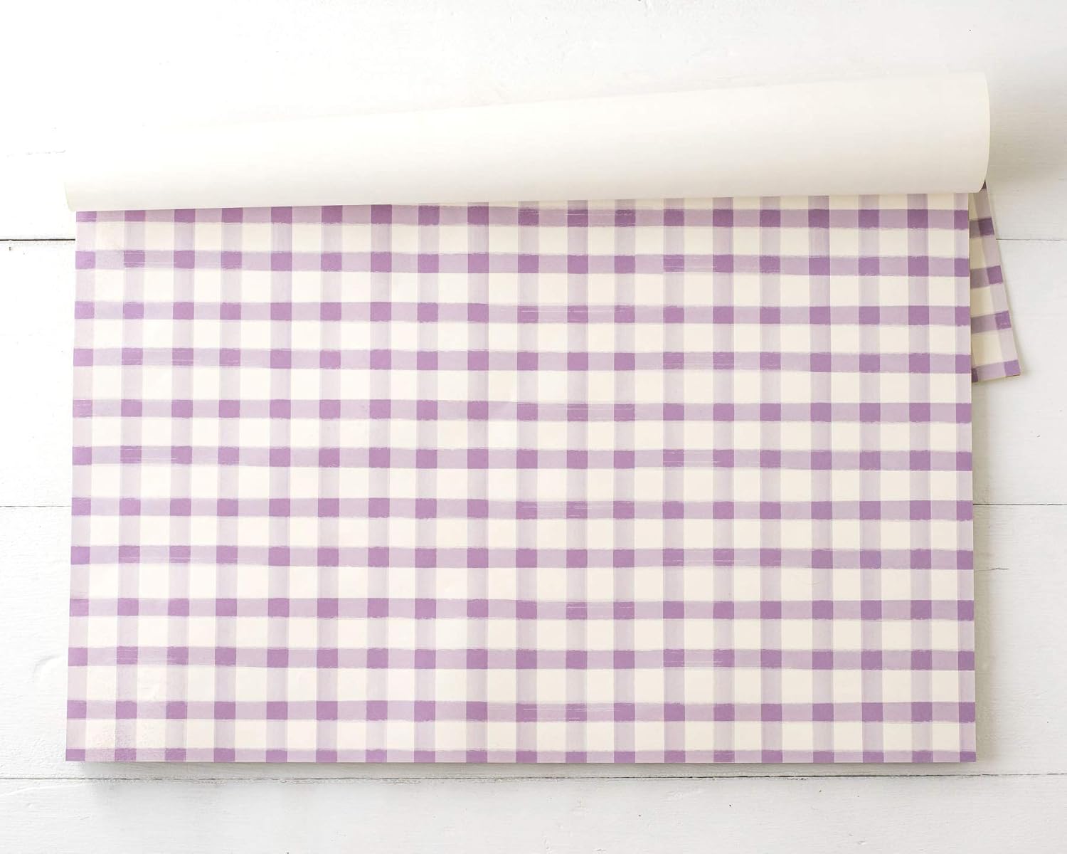 Pack of purple and white checkered placemats on a white background