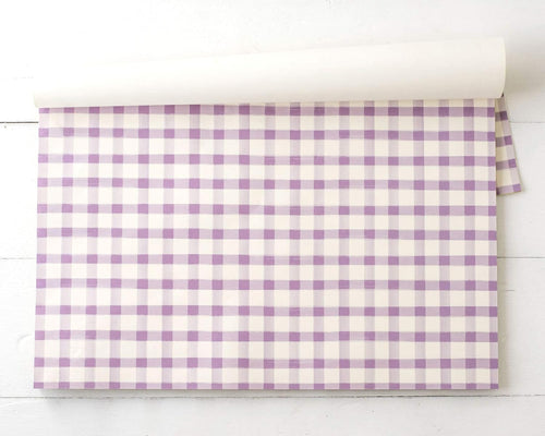 Pack of purple and white checkered placemats on a white background