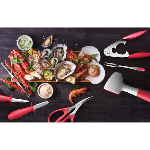 Assorted seafood platter with tools on a dark surface