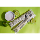 Shiver Stick frozen treat with lime slices and a bowl of sugar on a green background