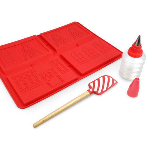 Mold for a gingerbread house, spatula, and tool for piping icing on a white background.