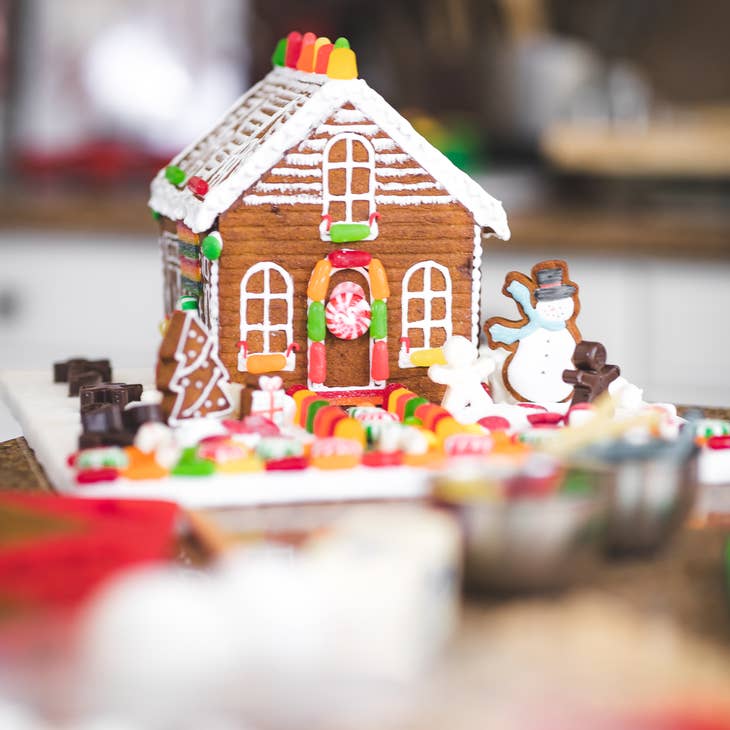 A gingerbread house with candy and icing decorations.