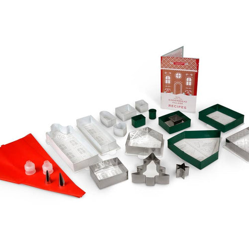 Molds and cookie cutters and a piping bag for making a gingerbread village.