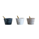 Three marble bowls with spoons on a white background.