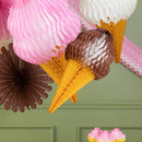 Decorative ice cream cone and flower decorations on a green wall.
