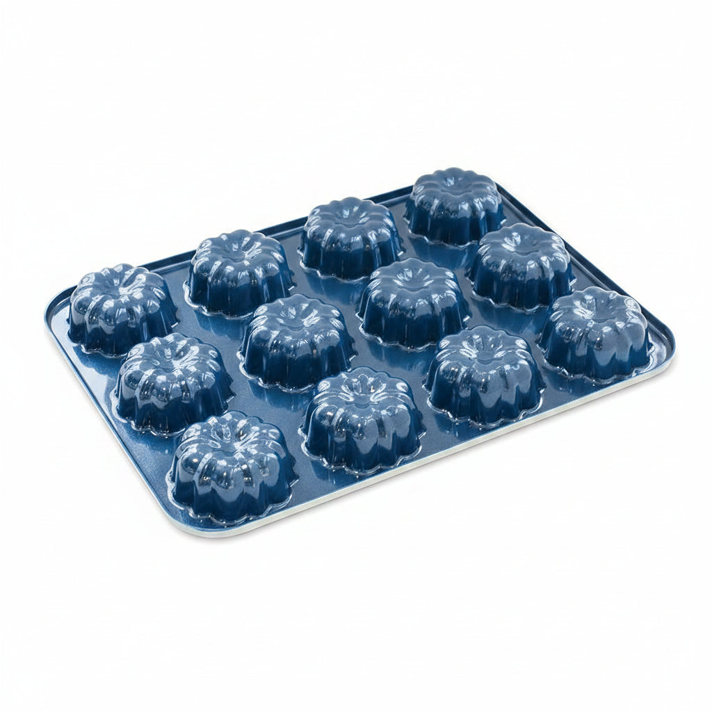 A navy mini Bundt cake pan with twelve molds on a white  background.