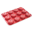 A red mini Bundt cake pan with twelve molds on a white background.