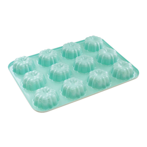 Turquoise mini bundt cake pan on a white background.