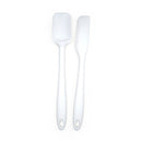 Two white silicone spatulas with metal cores and holes in the handles for hanging, displayed against a white background.