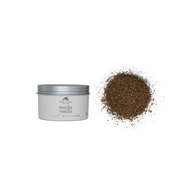 A small open container of Finch & Fennel Seasoning with Mocha-Vanilla Sea Salt, accompanied by a pile of brown sea salt outside the container.