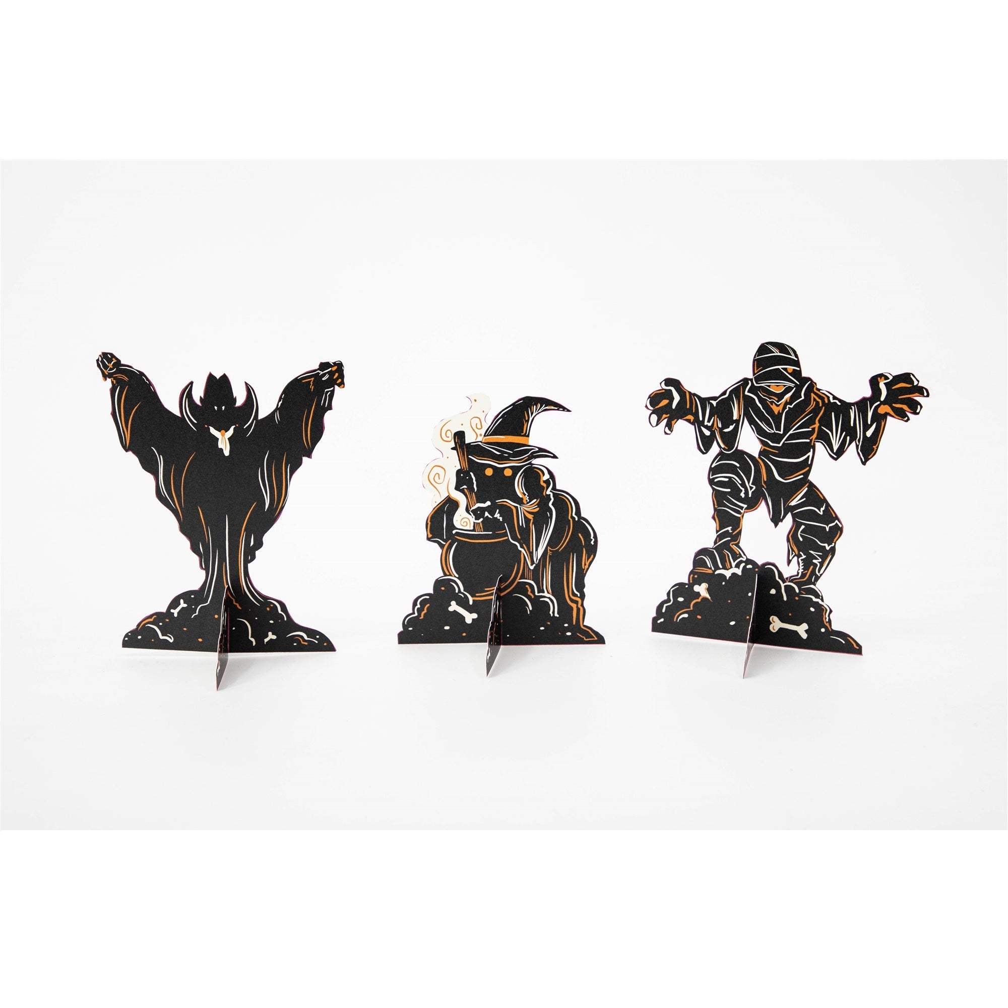 Three table ornaments in black and orange featuring a vampire, a witch, and a mummy, on a white background.