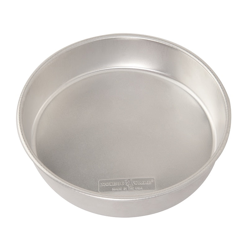 A round aluminum cake pan on a plain white background.