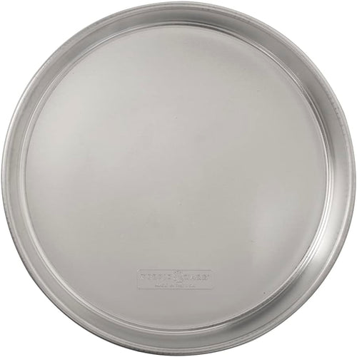 A round, silver-colored Nordic Ware cake pan with a smooth, shiny surface and encapsulated rims.