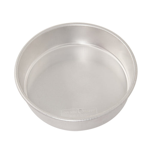 A 9 inch round cake pan made of aluminum with galvanized steel rims.