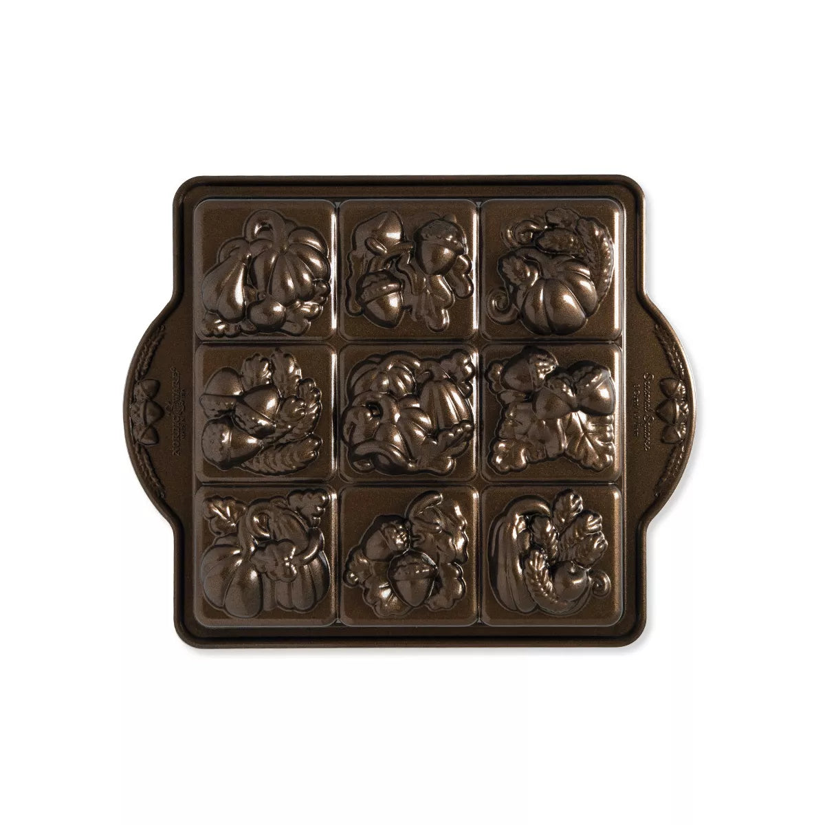 Baking mold with pumpkin and leaf designs on a white background