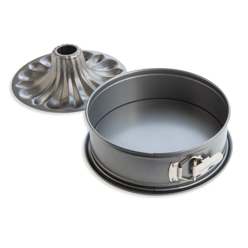 Metal cake pan with a removable bottom on a white background