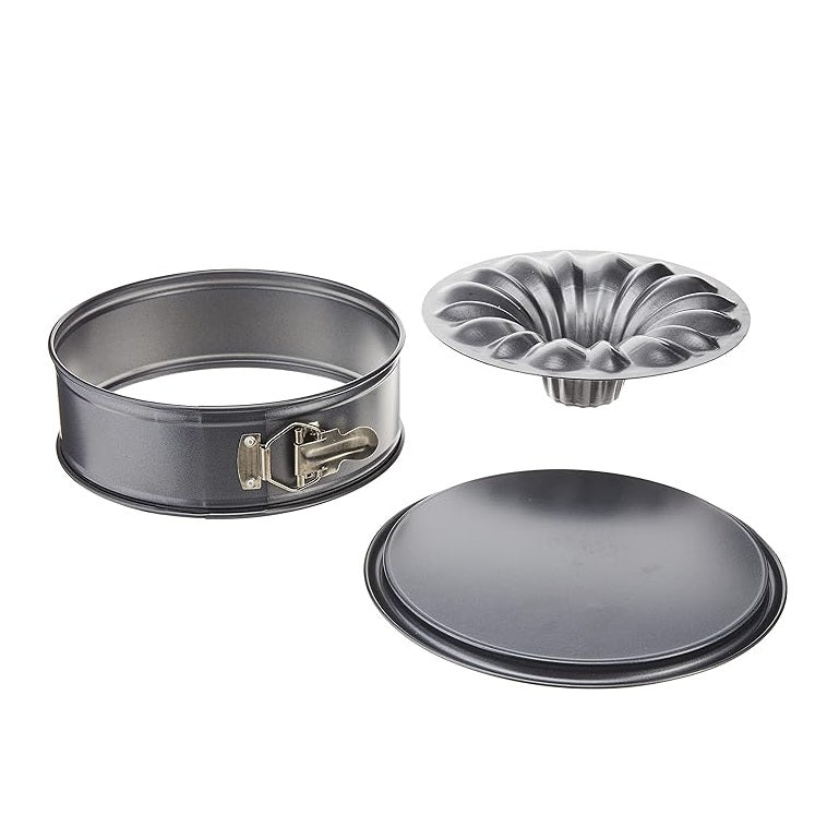 A three-piece metal springform pan set on a plain white background, including a round metal springform pan with a latch, a matching round metal lid, and a round metal fluted pan insert.