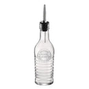 A glass bottle pourer with stopper and the year 1825 on it on a white background.