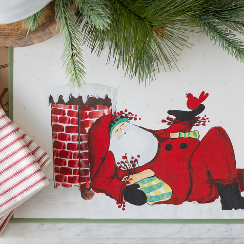 A placemat of Santa clause on a roof with birds and holly.