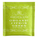 A single Harney & Sons Organic Citron Green tea bag packaged in a green foil wrapper with the brand's logo and product information printed on the front.