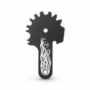 Black grill cleaning tool with sprocket-like design and white flame pattern on a white background