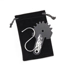 Grill cleaning tool with gear design on a black drawstring bag