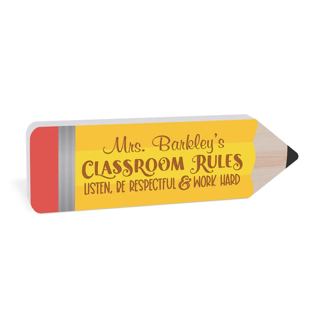 A sign in the shape of a pencil with a customized message on it.