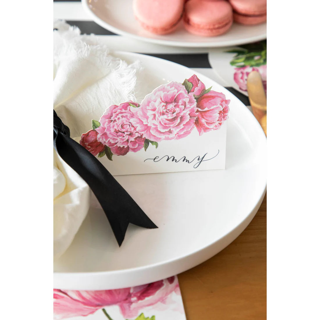 A peony place card on a plate.
