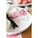 A peony place card on a plate.