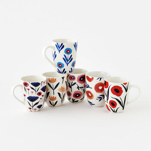 A set of six ceramic mugs with various floral and geometric patterns, including mugs with blue and red poppy designs.