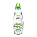 Clear measuring dressing shaker with green lid and measurement markings on a white background