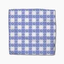 Blue and white checkered dish cloth with flower pattern on a white background