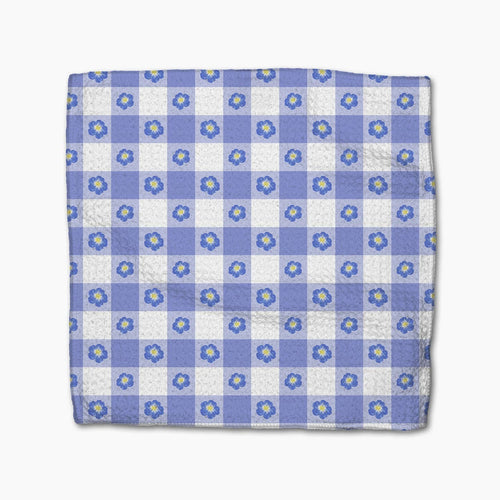 Blue and white checkered dish cloth with flower pattern on a white background